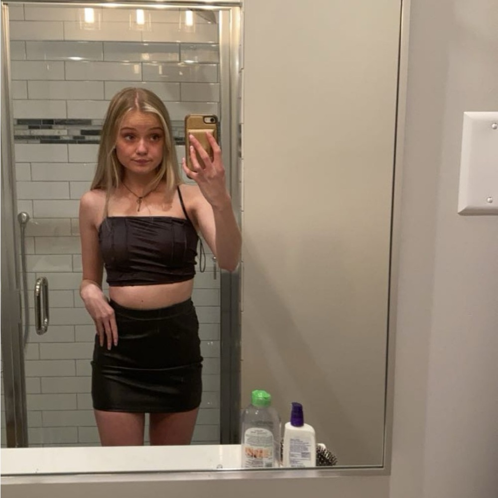Black, silky, spaghetti strap, corset crop top. Laces up in the back. Size: xs